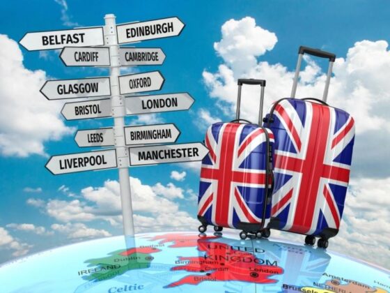UK travel suitcase and signposts 560x420